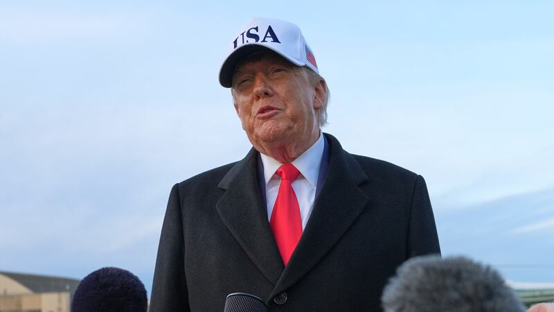 President Donald Trump speaks with reporters at Joint Base Andrews, Tuesday, Jan. 13, 2026, in...