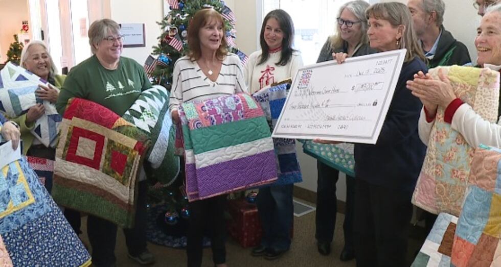 Members of the Truckee Meadows Quilters present a check for $3,000 and 15 handmade quilts to...